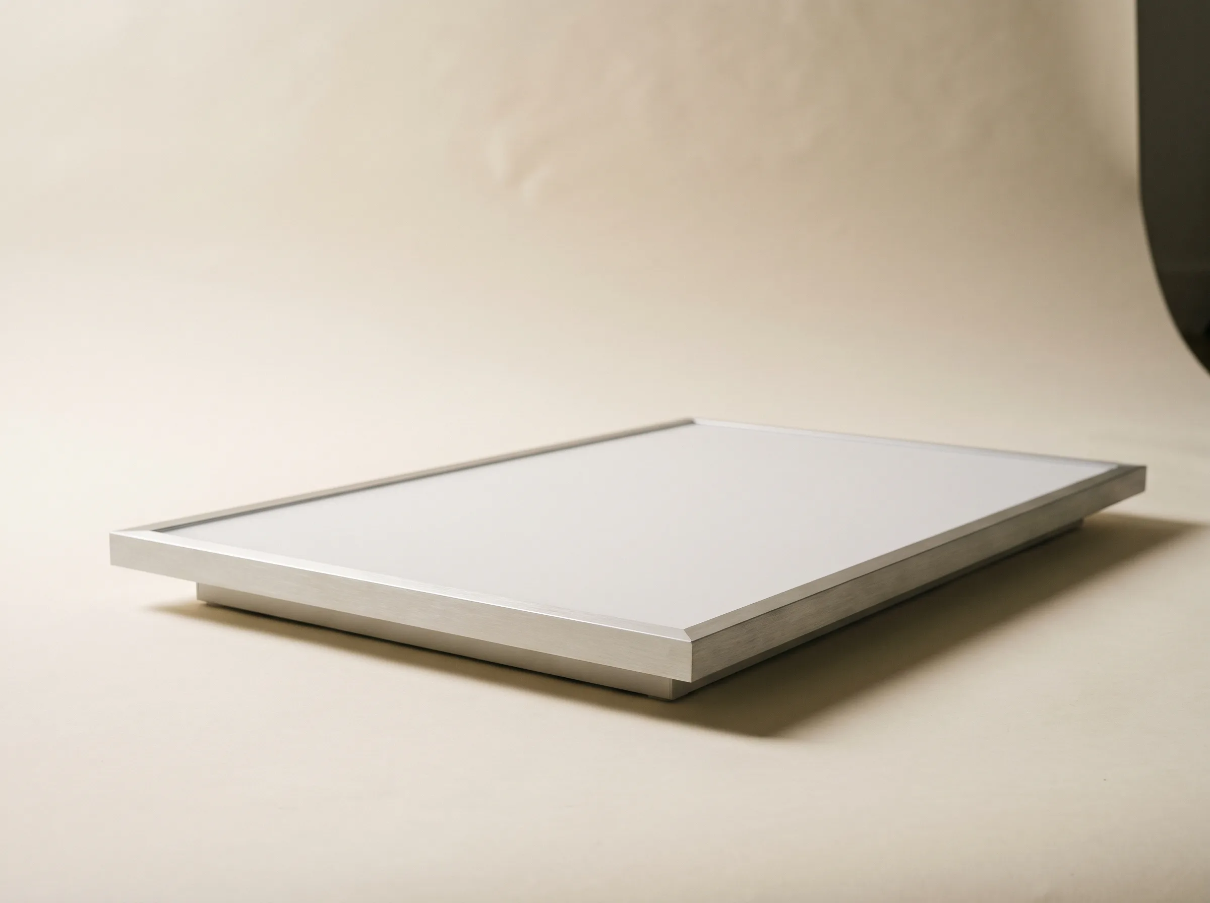 Slim rectangular LED backlit ceiling panel seen at a low angle, switched off, showing the aluminium edge frame and shallow body.